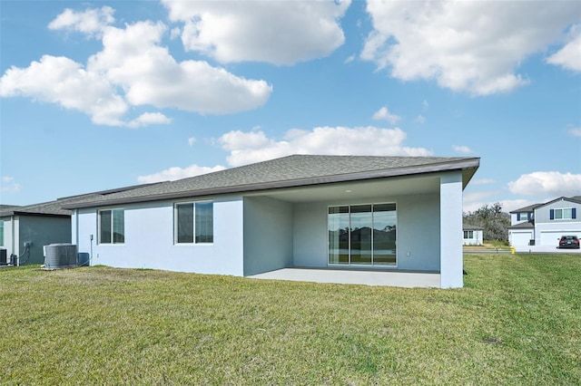 rear view of house featuring a yard, central AC unit, and a patio