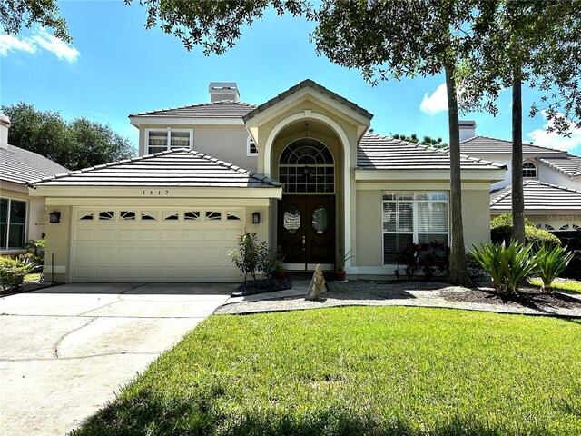 view of front of property with a garage and a front yard