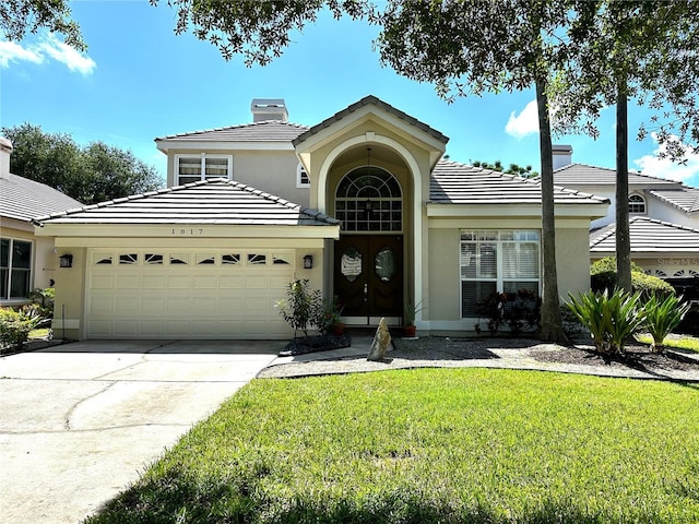 view of front facade featuring a front yard and a garage