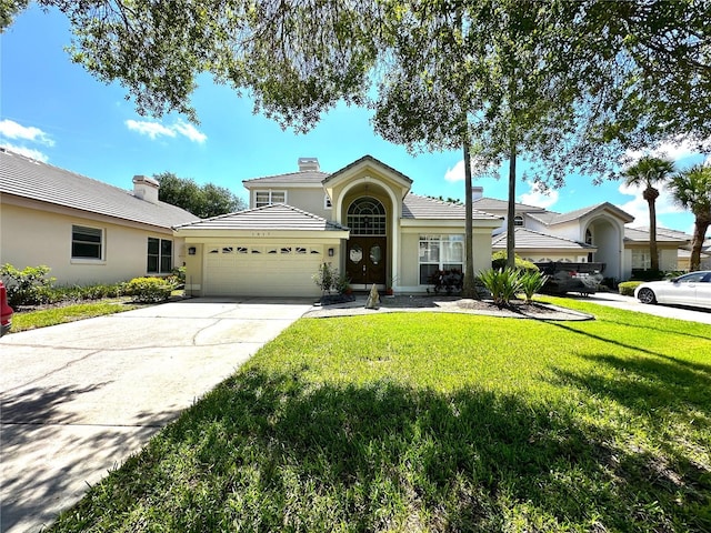 view of front of home featuring a garage and a front lawn