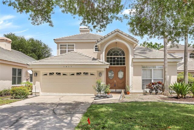 view of front of house featuring a garage and a front yard