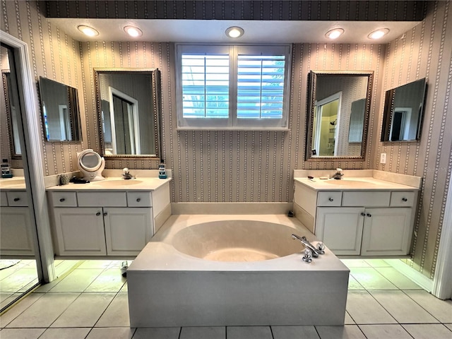 bathroom featuring tile patterned floors, vanity, and a bathing tub