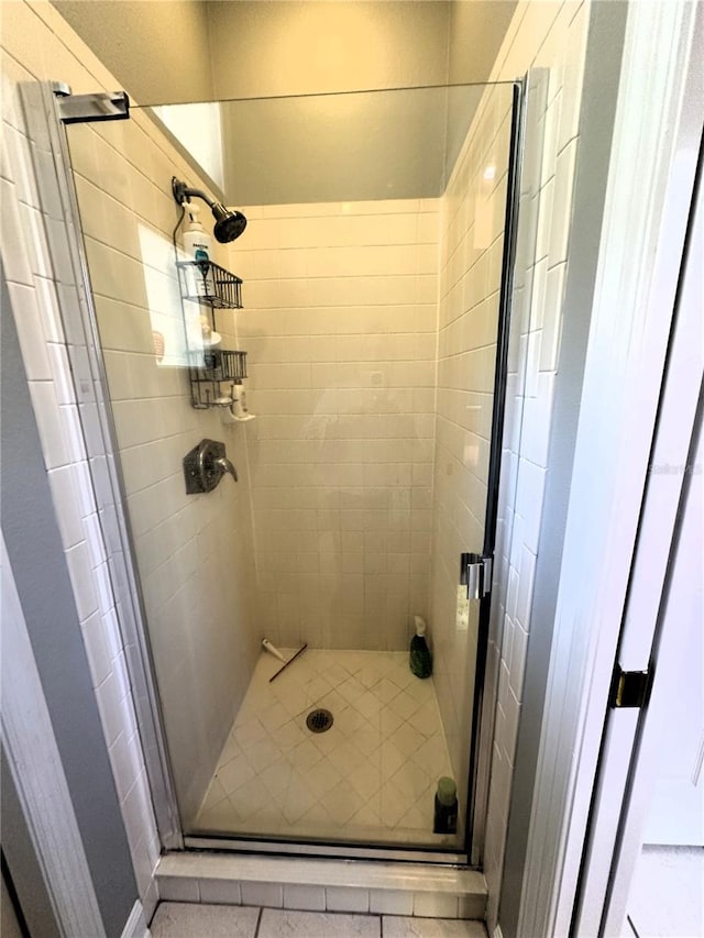 bathroom featuring a shower with shower door