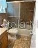 full bathroom featuring vanity, combined bath / shower with glass door, and toilet