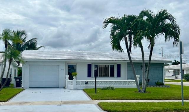 ranch-style home with a garage and a front yard