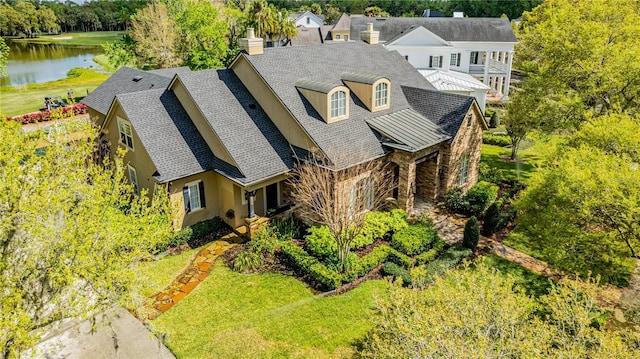 birds eye view of property with a water view