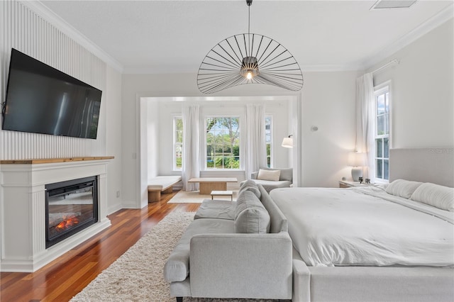 bedroom with crown molding and hardwood / wood-style floors