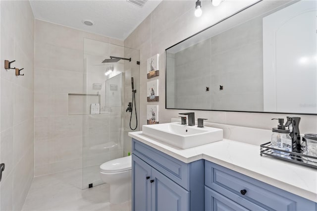 bathroom with vanity, tile walls, and walk in shower