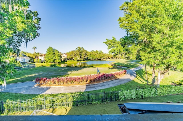 view of community featuring a water view and a yard