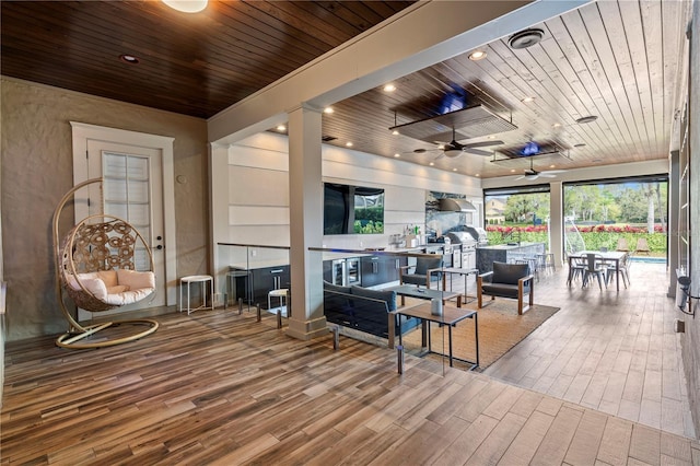 sunroom / solarium with ceiling fan and wooden ceiling