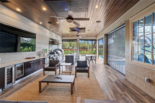 sunroom featuring ceiling fan, wood ceiling, and wine cooler