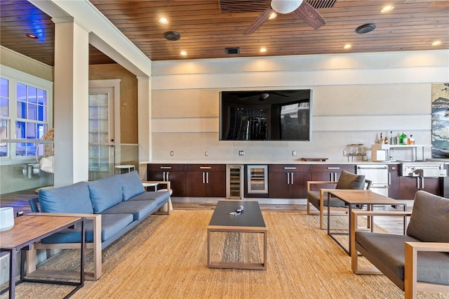 living room featuring ceiling fan, wooden ceiling, and beverage cooler