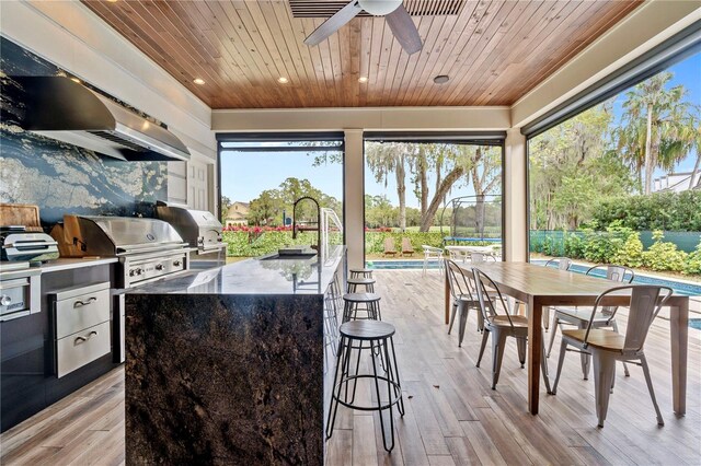 interior space featuring grilling area, ceiling fan, area for grilling, and sink