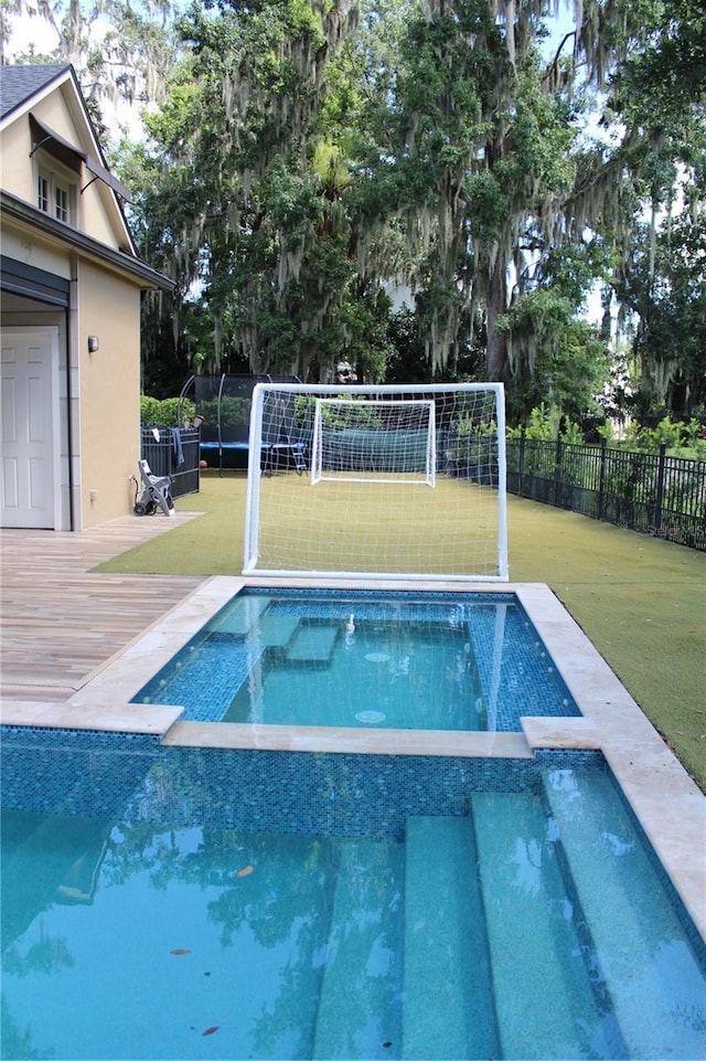 view of pool with a yard