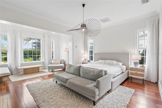 bedroom featuring dark wood-type flooring and ornamental molding