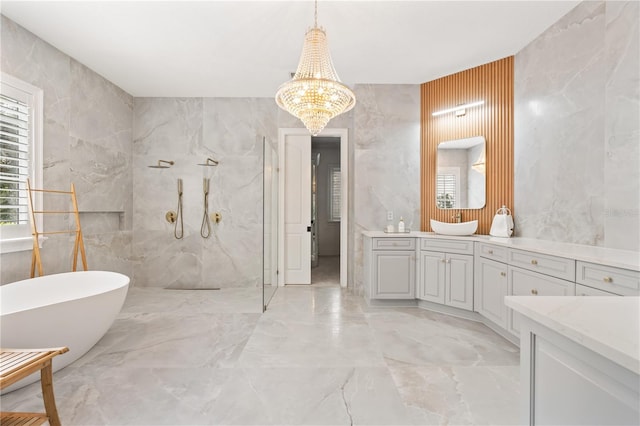 bathroom with a chandelier, a bathtub, and vanity