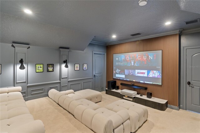 carpeted cinema with crown molding and a textured ceiling