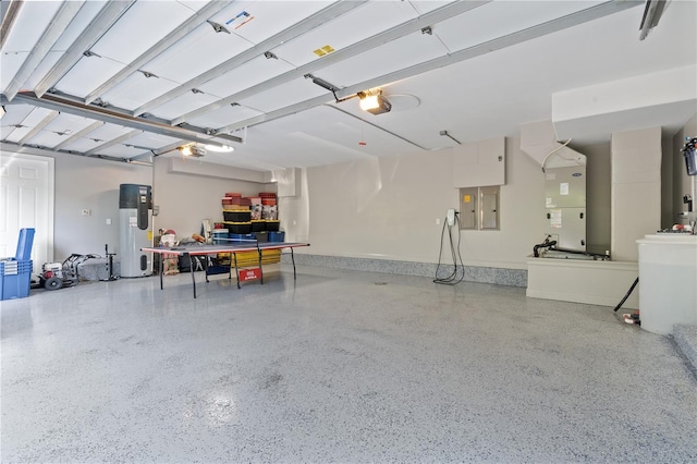 garage featuring electric water heater, a garage door opener, heating unit, and electric panel