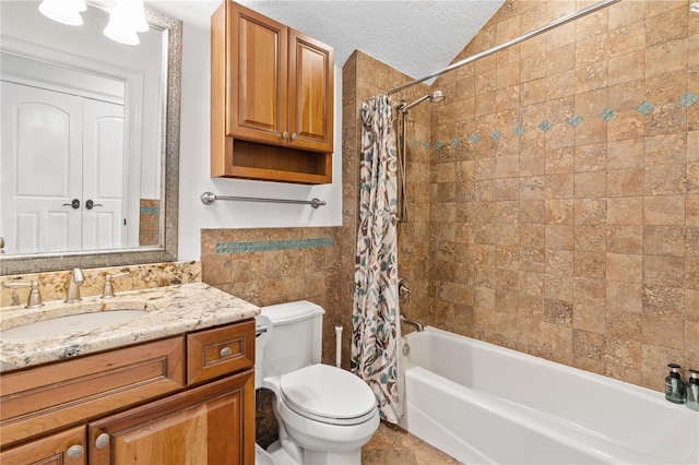 full bathroom featuring toilet, shower / bath combination with curtain, lofted ceiling, a textured ceiling, and vanity