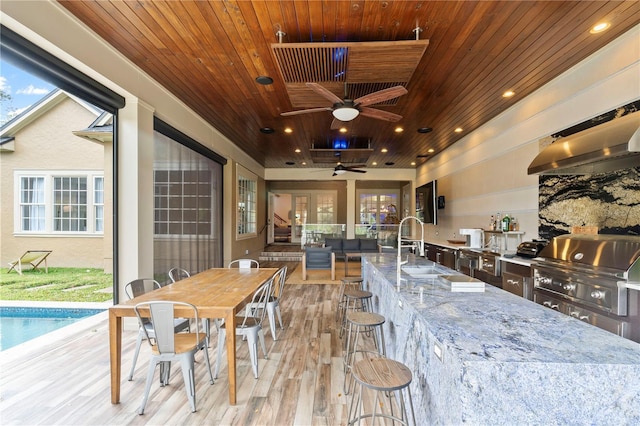 interior space featuring ceiling fan, wooden ceiling, and light wood-type flooring