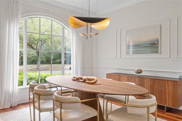 dining area featuring light wood-type flooring and radiator heating unit