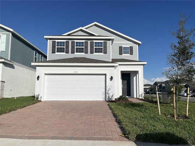 front of property featuring a garage and a front lawn