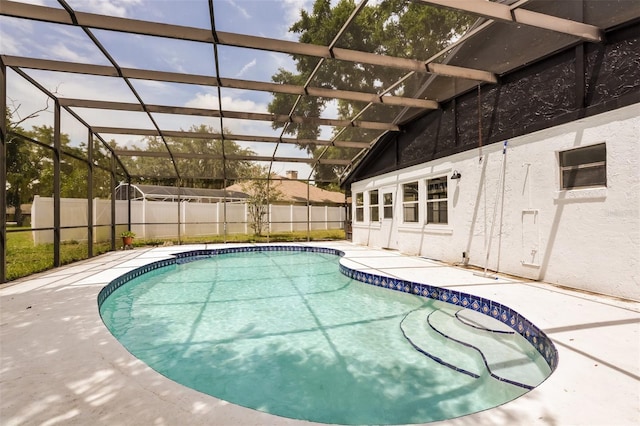 view of swimming pool featuring a patio area and a lanai