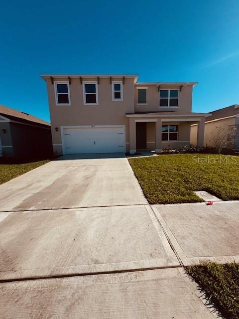 view of front of home featuring a front yard and a garage