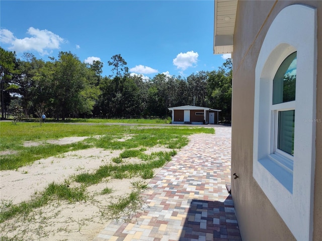 view of yard with a garage and an outdoor structure