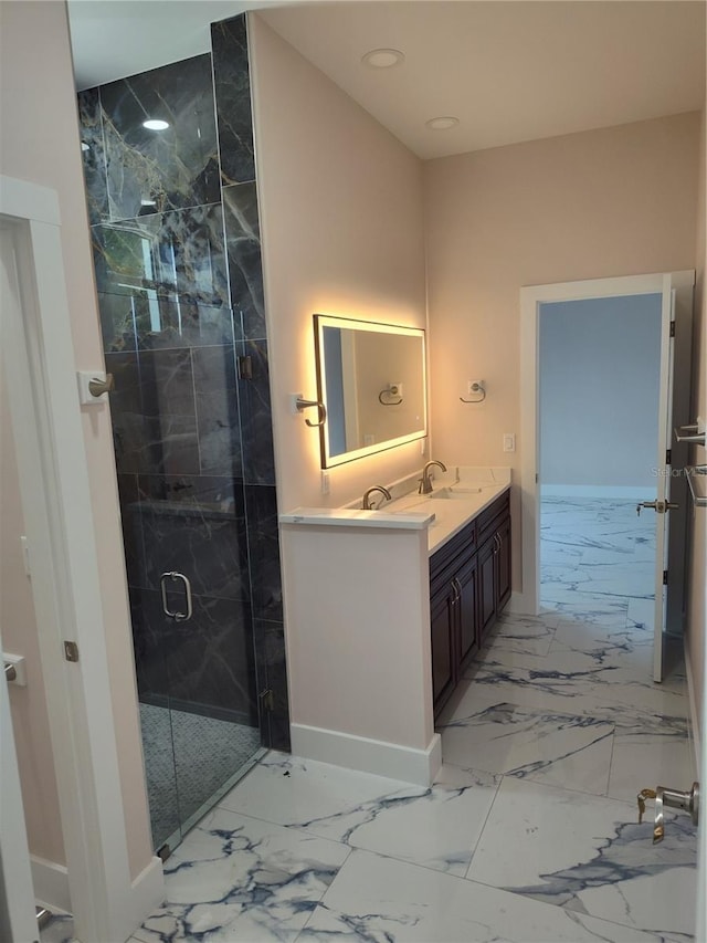 bathroom with vanity and a shower with door