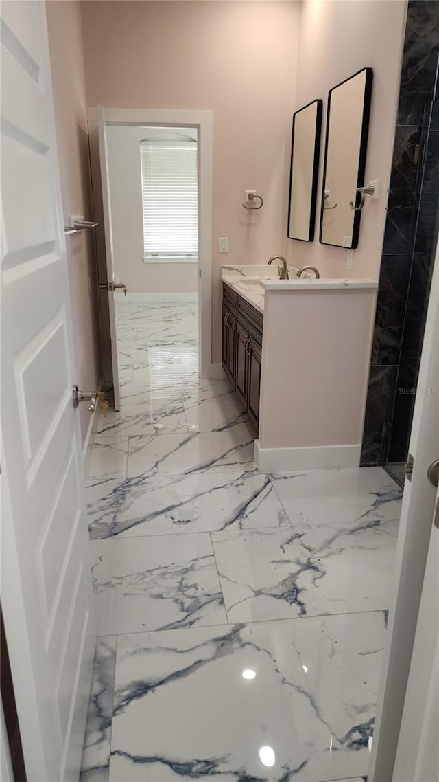 bathroom with vanity and a shower