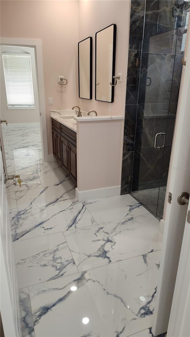 bathroom featuring vanity and a shower with shower door