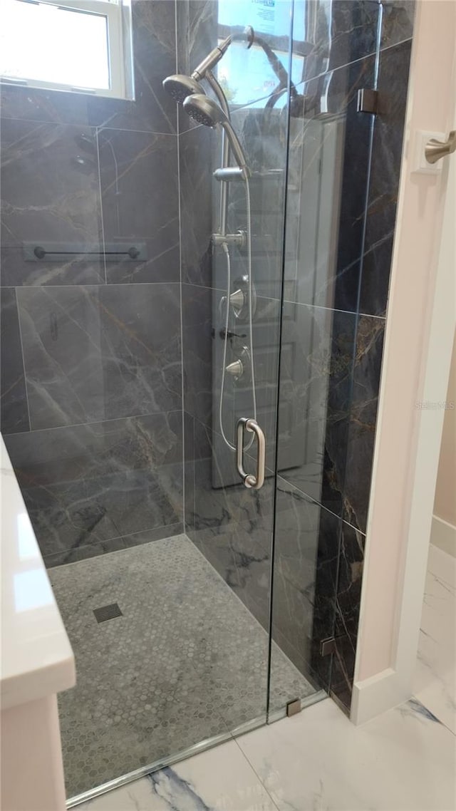 bathroom featuring a shower with door