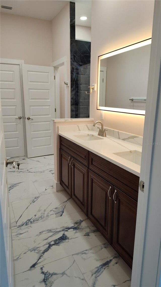 bathroom with walk in shower and vanity