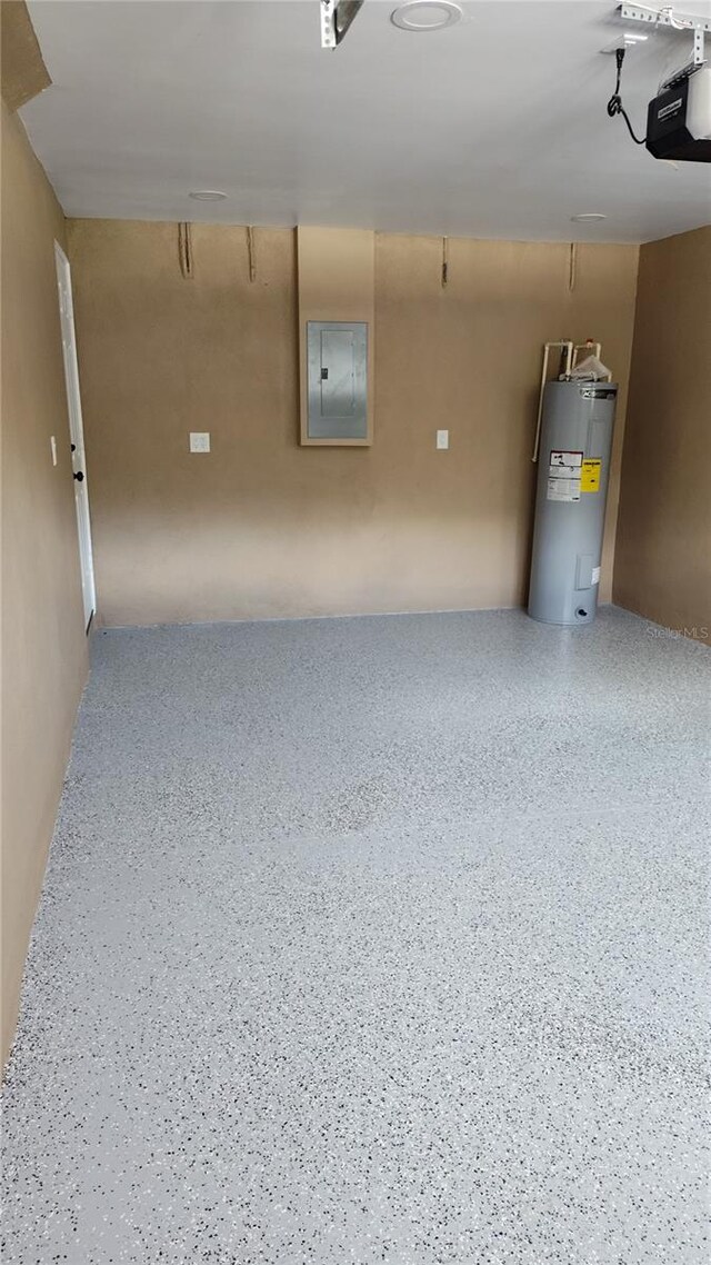 garage featuring a garage door opener, electric water heater, and electric panel