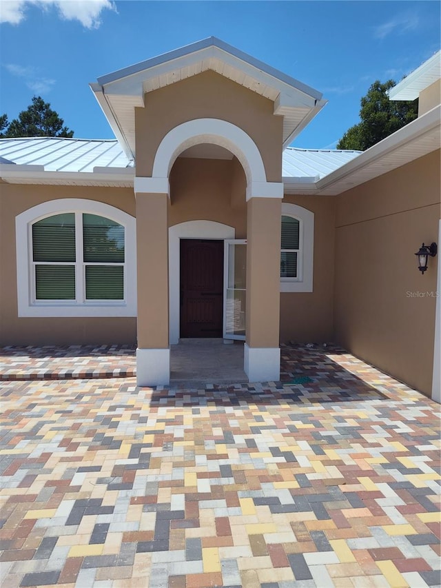 doorway to property featuring a patio area