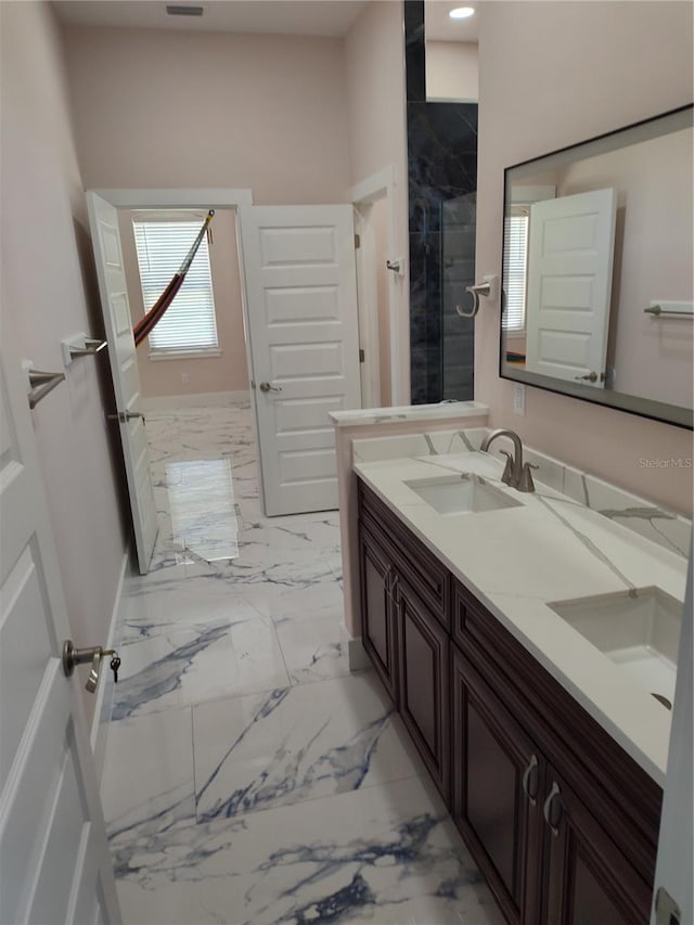 bathroom with vanity and a shower