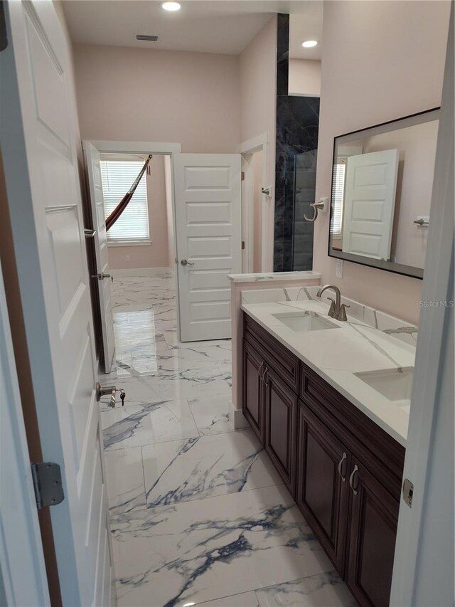 bathroom with vanity and a shower