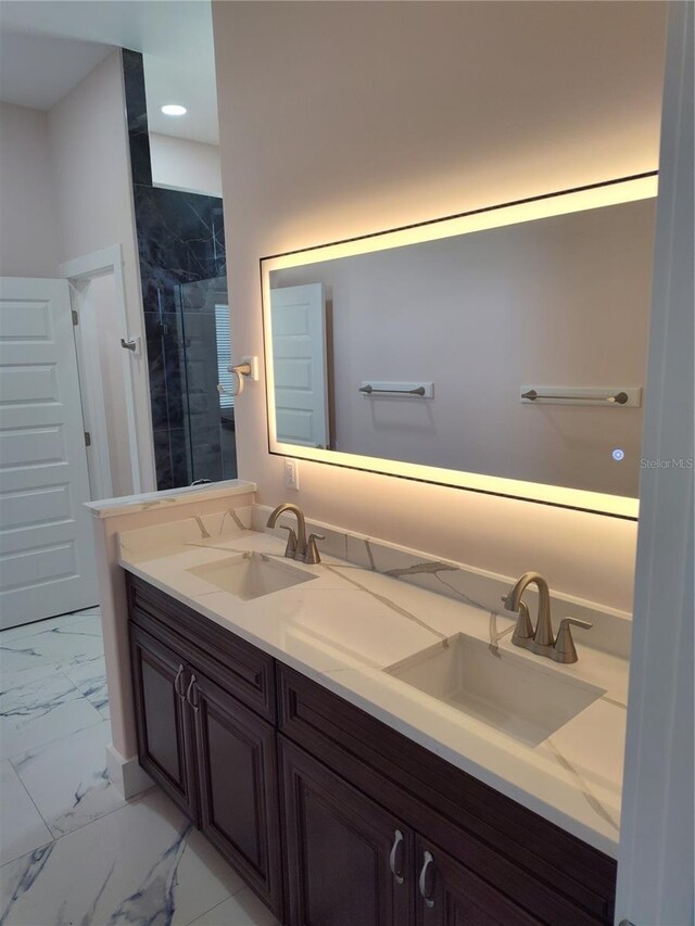 bathroom with vanity and tiled shower