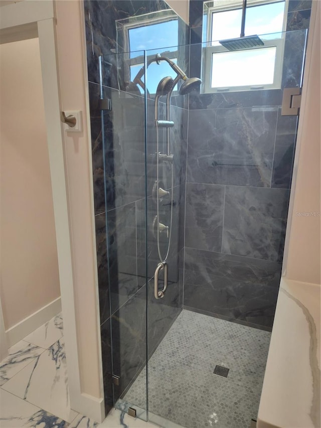 bathroom with a shower with door