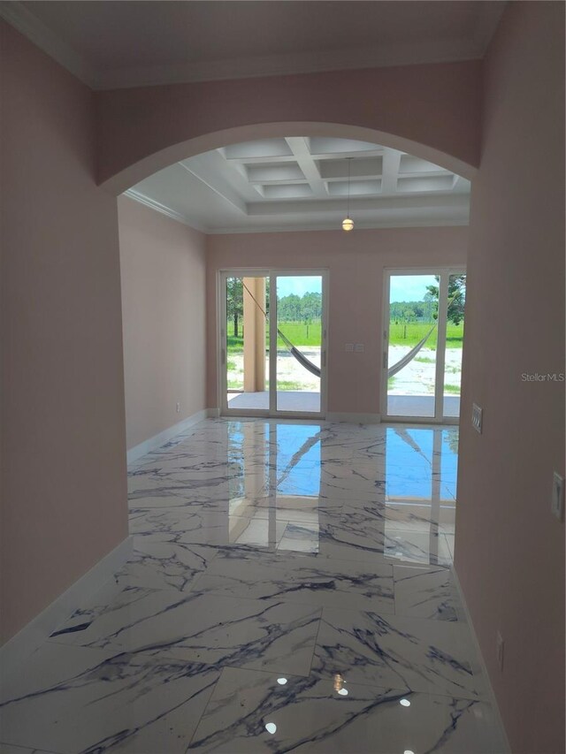 unfurnished room featuring coffered ceiling, beam ceiling, and ornamental molding