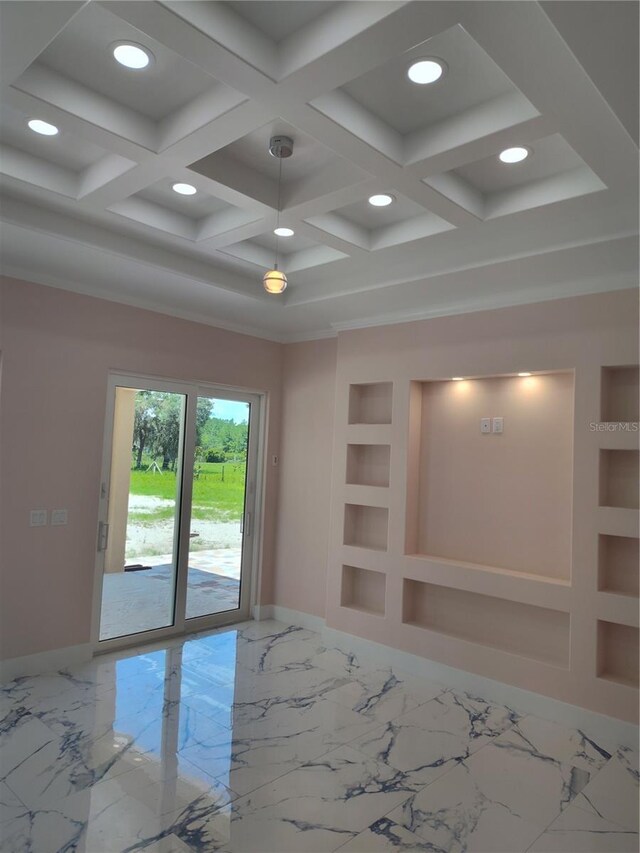 spare room with coffered ceiling and built in shelves