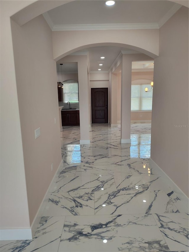 corridor with crown molding and sink