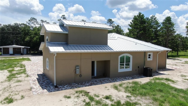 back of property featuring central AC unit