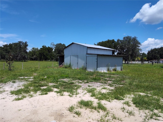 view of outdoor structure with a rural view