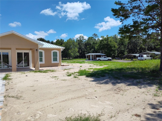 view of yard with a carport