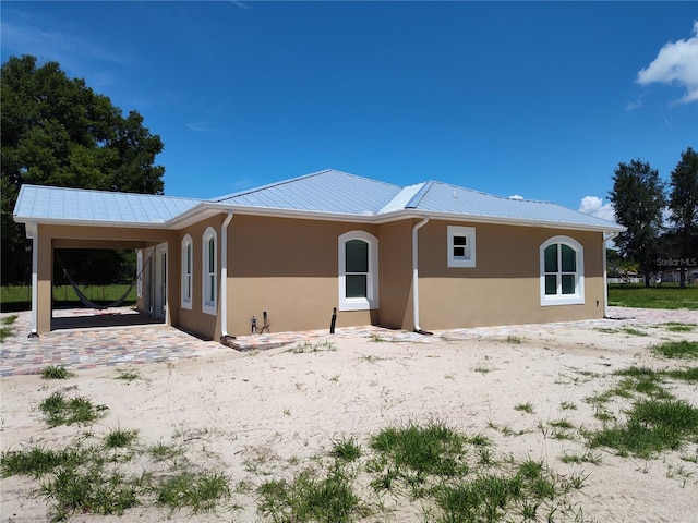 rear view of property with a carport