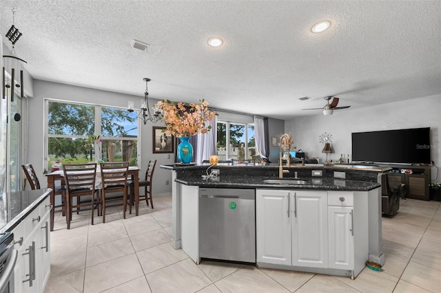 kitchen with a center island with sink, a sink, white cabinets, stainless steel dishwasher, and open floor plan