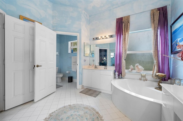 full bathroom featuring tile patterned floors, toilet, a bath, and vanity