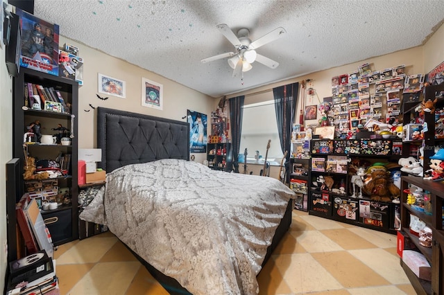 bedroom featuring tile patterned floors, a textured ceiling, and ceiling fan